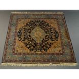 A European hand knotted wool rug with light blue medallion in indigo field, 225cm x 220cm and