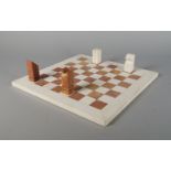 A Flli Mannelli traventine chess set, circa. 1970, the block form pieces made in pink and pale cream