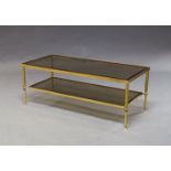 A continental brass and smoked glass two tier coffee table, c.1960s, 41cm high x 108cm wide x 47cm