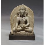 An Indian stone carving of a Buddha, late 19th/20th century, seated in meditation on a lotus throne,