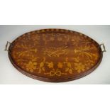 An Edwardian oval tray, inset with a panel of musical instruments within wreathes of flowers and