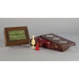 A white and red stained bone chest set, 19th century, in a wooden box bearing the label 'The Game of