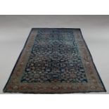 A West Persian carpet with all over design in a deep blue field, 517cm x 310cm, another carpet