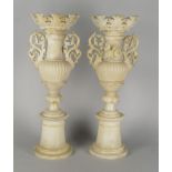 A pair of Italian white alabaster lamp bases, late 19th/early 20th century, in the form of urns with