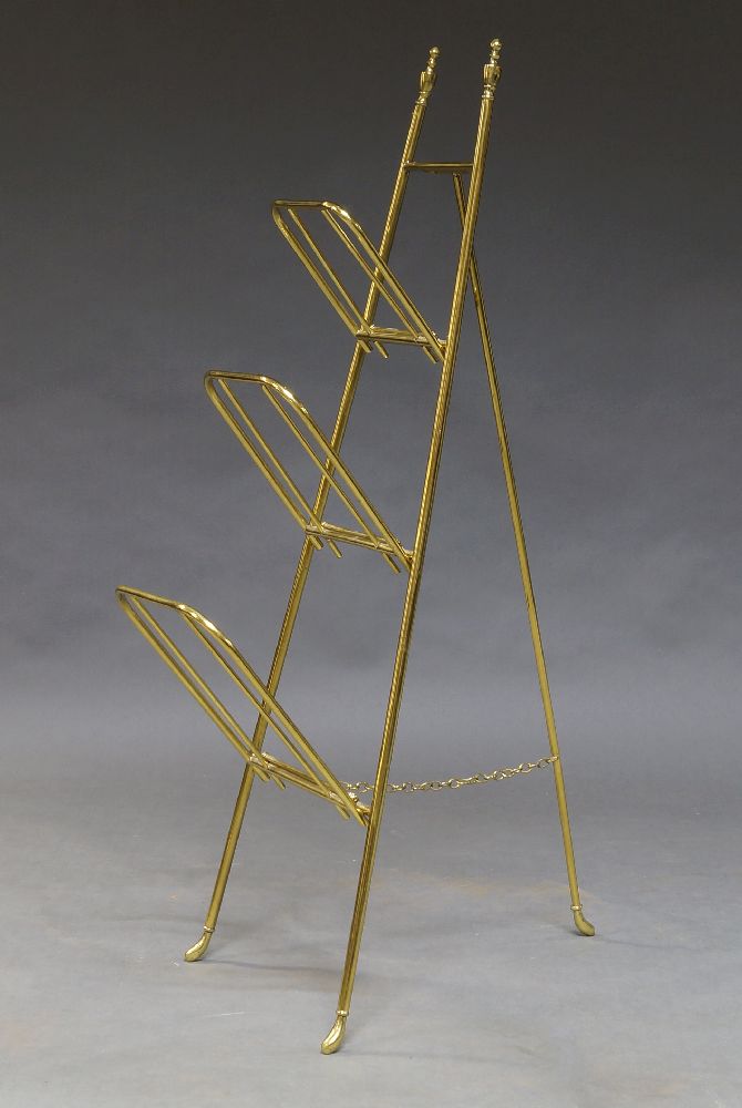 An Edwardian brass folding magazine or paper rack, with three drop down hinged shelves, 103cm