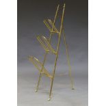 An Edwardian brass folding magazine or paper rack, with three drop down hinged shelves, 103cm