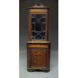 An Edwardian mahogany and marquetry inlaid corner cabinet, the top with broken pediment above single