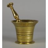 A polished bronze mortar and pestle, 18th century, the mortar 8.5cm high, the pestle 18.5cm (2)