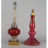 A clear glass and ruby glass lamp base, 20th century, with facetted stem and sconce, with
