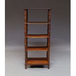 A Victorian mahogany five tier what not, the rectangular shelves, on turned supports to bun feet,