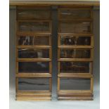 A pair of seven-section Globe Wernike oak and glazed stacking bookcases, with retailers stamp to