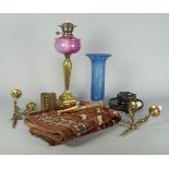 A Victorian brass oil lamp, with a cranberry coloured glass reservoir, 51cm high, together with