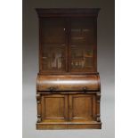 A Victorian mahogany cylinder roll top secretaire bookcase, the moulded stepped cornice, above two