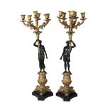 A pair of French six light bronze and gilt bronze candelabra, late 19th century, modelled as male