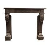 A Louis XVI style chimneypiece, 19th century, carved in Namur Black Marble with scrolled jambs and