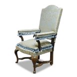 A French walnut high back reclining chair, 18th Century and later, upholstered in blue and cream