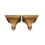 A pair of Victorian oak wall brackets, in the Gothic taste, carved with rows of rosettes and