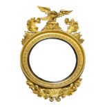 A Regency gilt wood convex mirror, the crest surmounted with eagle and acanthus leaves, 129cm high x