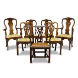 A set of four Dutch walnut veneered dining chairs, early 19th century, with shaped central splat
