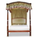 A George III style mahogany tester bed, 19th century and later, the arched and pierced canopy,