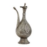A Qajar tinned copper engraved ewer, Iran, late 18th century, of drop form, on a played foot, signed