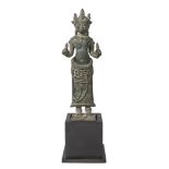 A Khmer Bayon style bronze figure, 13th century, depicting Prajnaparamita standing, wearing