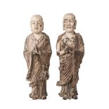 A pair of Chinese carved wood and painted gesso Lohan, 18th/19th century, both carved standing, with