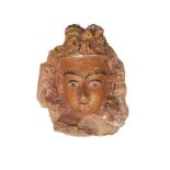 A Tibetan terracotta head of Shiva, 19th century, with later painted features, 19cm high