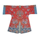 A Chinese silk embroidered robe, 19th century, decorated with roundels of flowering chrysanthemum on