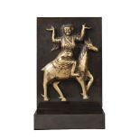 A Tibetan gilt copper repousse plaque, 17th/18th century, modelled with a tantric divinity astride a