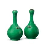 A pair of Chinese monochrome apple green porcelain garlic-head vases, 18th century, with bulbous