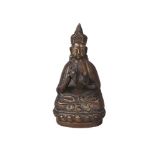 A Tibetan bronze figure, mid-19th century, depicting a bearded deity playing ceremonial Tingsha,