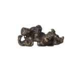 A Chinese bronze scroll weight, Ming dynasty, 17th century, modelled as Liu Hai reclining, holding