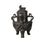 A large Chinese bronze tripod censer and cover, Ming dynasty, 16th century, the body cast with a