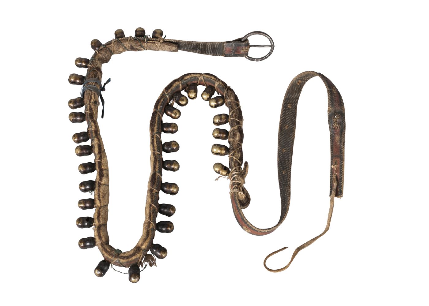 A Nepalese animal belt, late 19th century, adorned with brass bells, with yellow silk scarf, 110cm