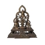 A Nepalese bronze figure group, 19th century, centred with Avalokitesvara flanked by Buddha and