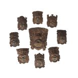 A collection of nine Nepalese copper alloy mask appliques, 19th century, of various deities, now