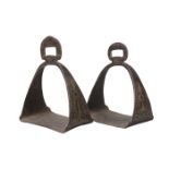 A pair of Tibetan damascened iron stirrups, 19th century, decorated to the tapering sides with