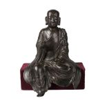 A Chinese bronze seated Lohan, Ming dynasty, 16th/17th century, seated at 'Royal Ease', with
