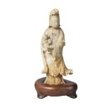 A Chinese soapstone carving of Guanyin and a child, 18th/19th century, carved standing, with cloud-