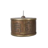A Tibetan copper prayer wheel, 19th century, engraved with text and a double vajra, 12cm diameter