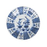 A Chinese porcelain plate, Kangxi, late 17th century, painted in underglaze blue with flowering