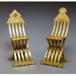 A near pair of middle Eastern gilt side chairs, 20th Century, with overall carved decoration, the