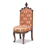 A Victorian carved oak side chair in the Gothic style, circa 1840, the top rail with carved acanthus