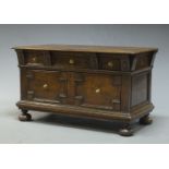 A Jacobean style chest, early 20th Century, the rectangular top above long frieze drawer, over