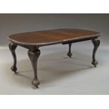 A Queen Anne style mahogany wind out dining table, early 20th Century, with one additional leaf, the