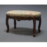 A Continental style needlework and mahogany framed stool, 20th Century, the shaped floral needlework