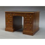 An Edwardian mahogany partner's desk, the rectangular top inset with black leather writing