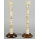 A pair of Japanese bone candlesticks, late 10th/early 20th century, each of sectional design, carved