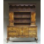 A George III and later oak and inlaid Welsh dresser, the top section with dentil moulded cornice